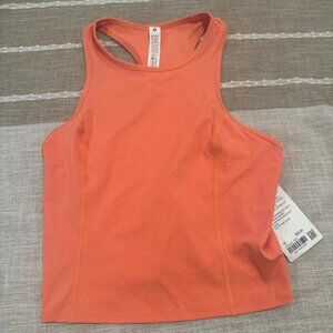 Orange Lululemon Nulux Racerback Cropped Run tank top.